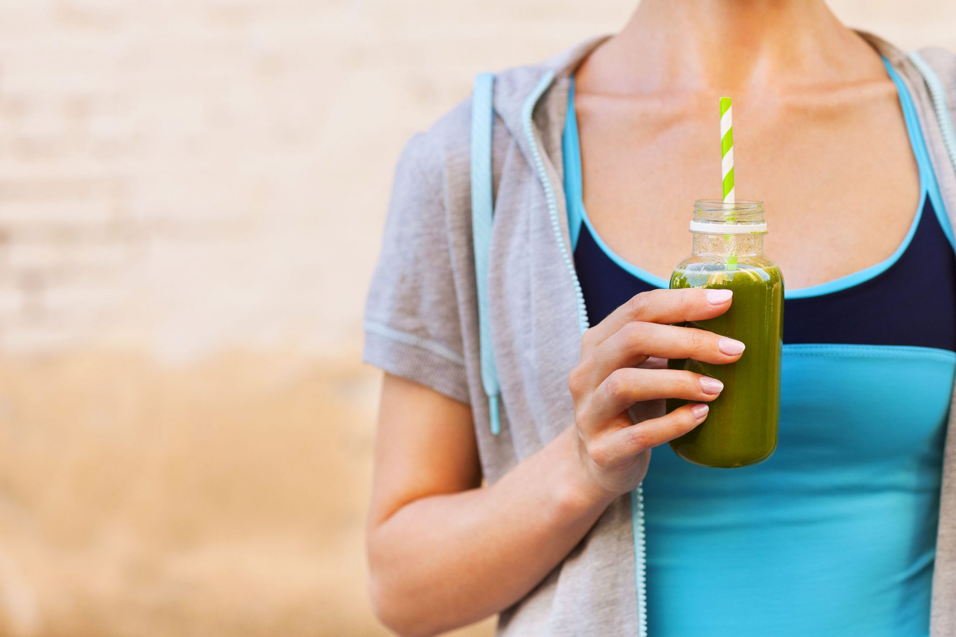 50767283 - woman drinking vegetable smoothie after fitness running workout on summer day. fitness and healthy lifestyle concept